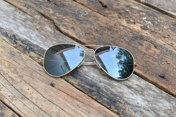 black sunglasses isolated on a wood background