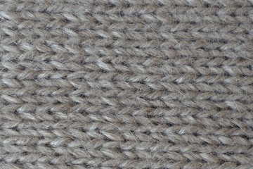 Close-up of grey handmade plain knit stitch fabric