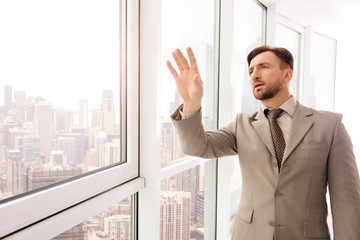 Fototapeta premium Concentrated serious businessman touching virtual screen