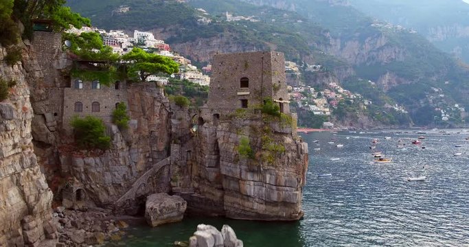 Discovering Positano village aerial shot with boats in sea
