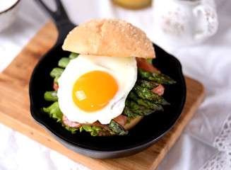 Healthy burger with salted salmon, asparagus and egg.