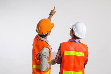 A team of construction workers with orange helmets at work place