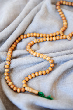 Mala of Buddhist prayer in wood and gray shawl for a session of yoga and meditation