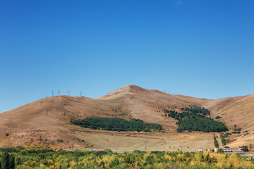 Mountains around Sevan lake and white clouds blue sky on a sunny day, Armenia
