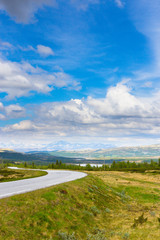 Fototapeta na wymiar Road in Norway. Summer landscape with blue sky and mountains