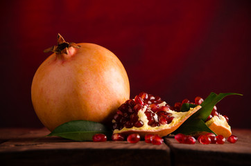 the pomegranate is ripe. cut into pieces of ripe pomegranate. on wooden boards.