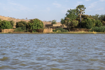 Huts village on River Niger in Niger seen from a pirogue, Niger, West Africa
