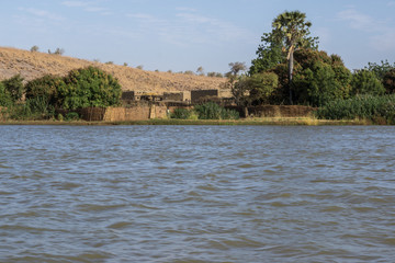 Huts village on River Niger in Niger seen from a pirogue, Niger, West Africa