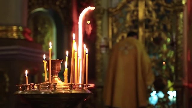 Priest is cross oneself and prays in orthodox church