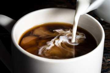 Pouring Cream into a Cup of Coffee - 143441161