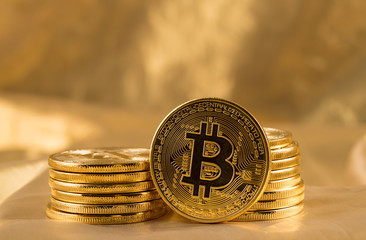 Stack of bitcoins with gold background