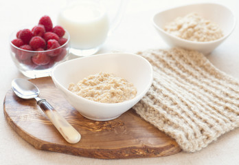 Oatmeal breakfast with raspberries and milk