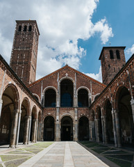 Fototapeta na wymiar Towers in courtyard of Saint Ambrogio basilica, Milan, Italy. Summer travel postcard.