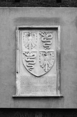 Closeup bas-relief black and white emblem details of Sforza Castle (Palazzo Sforzesco), one of the main landmarks and tourist attractions of Milan, Italy.
