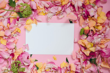 Valentines day or wedding mock up scene with blank card. Floral border of fresh flower petals