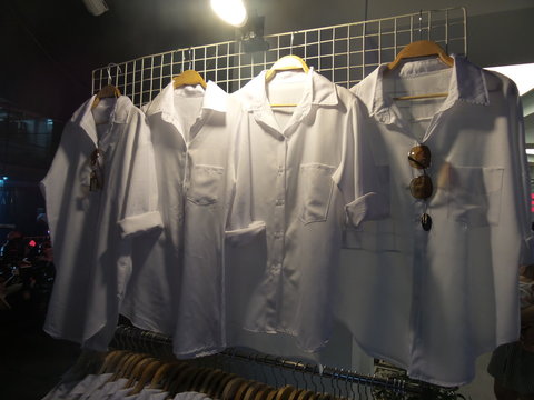White shirt hang on the grille in night time
