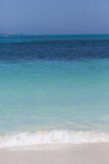Fototapeta na wymiar Wave on the beach. Turquoise water of the Caribbean sea. Vertical image.