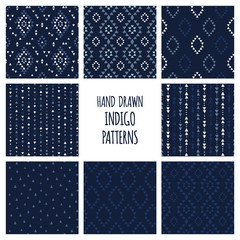 Set of hand drawn indigo blue patterns. Seamless vector navajo backgrounds with triangles, arrows, rhombuses and diamonds.