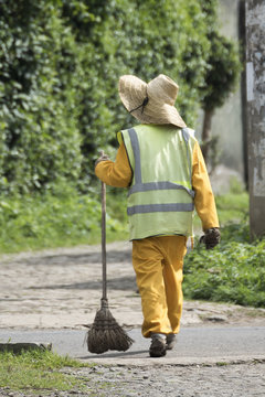 Ethiopian Street Cleaner in uniform walking on road in Addis Ababa