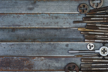 Set of various equipment for threading with copy space, carpenter tool old rusty metal background.