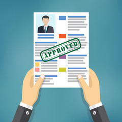 Hand holding approved resume.