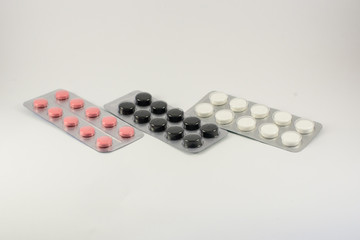Different medicines. Tablets, pills in blister pack. Medications drugs on a white background