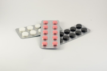 Different medicines. Tablets, pills in blister pack. Medications drugs on a white background