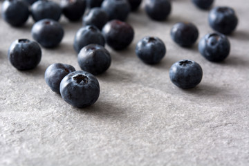 Blueberries in crystal bowl on gray stone
