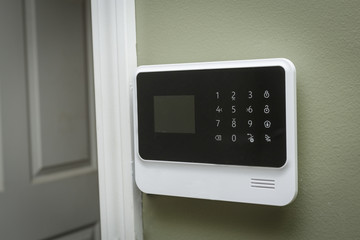 security system keypad beside an open door