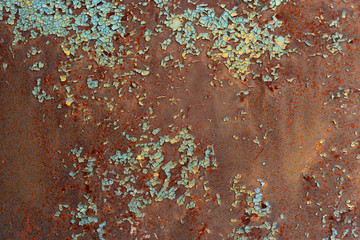 Peeling blue paint on rusted metal texture. Pattern of blue grunge material