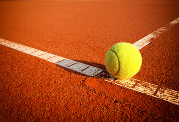 Tennis balls on a tennis clay court