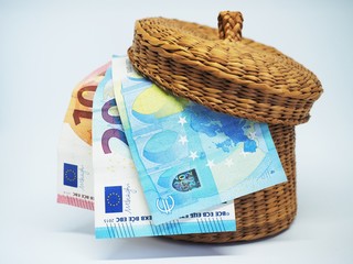  Money and basket on a light background