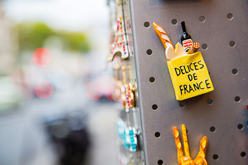 Small magnet souvenirs on the street in Paris, France. Baguette gift present. 