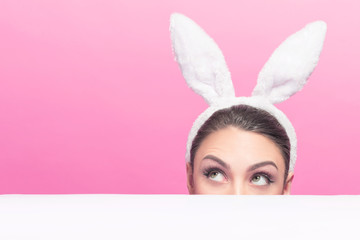 Woman - easter bunny looking on copy space