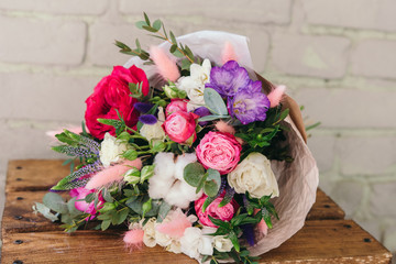 Stylish bouquet of fresh flowers. Composition from freesia, roses, eucalyptus leaves. Close up