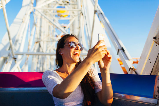 Woman taking pictures while in amusement park ride