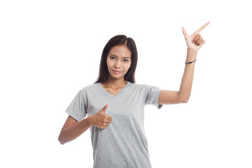 Young Asian  woman point and thumbs up.