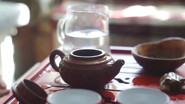 The tea ceremony. Woman makes tea in a teapot. Close-up.