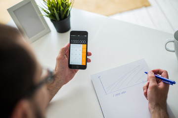 Businessman draws a graph in a notebook