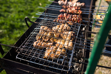 Grilling marinated shashlik on a grill. Shashlik is a form of Shish kebab popular in Eastern, Central Europe and other places.