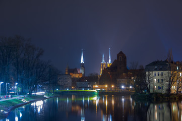 Fototapeta na wymiar The Cathedral of St John Baptist by a full moon night Ostrow Tumski Wroclaw Breslau Poland