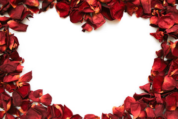 Heart shape of red petals on white background. Valentine's day with beautiful rose petals. Love backdrop