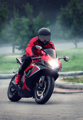 Biker in helmet ride on the red motorcycle