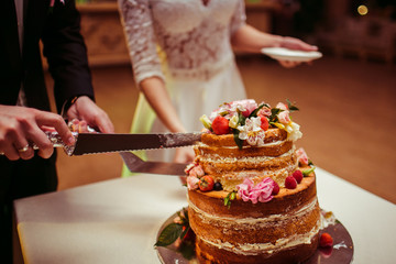 The brides cutting a wedding cake