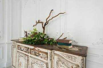 Romantic autumn scenery for photo shoots. Old books, green branch, candles