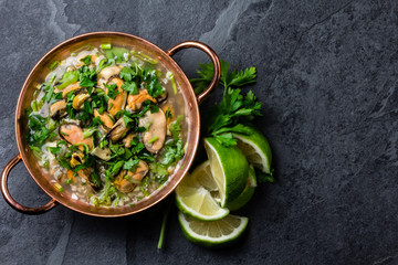 Seafood ceviche or mariscal in copper bowl - traditional Latin American dish with seafood, onion and lemon
