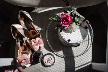 Wedding rings, a bouquet of lavender and beige bridesmaid shoes