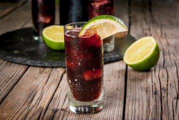 Traditional Spanish alcoholic drink, cocktail, Calimocho. With wine, cola, lime juice and ice. Decorated with pieces of lime. Copy space 