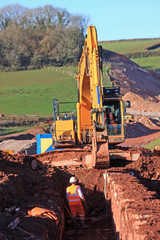 Obraz premium Digger digging a trench