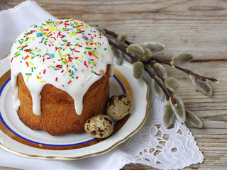 Easter composition of sweet bread, paska and eggs on wooden background. Orthodox kulich. Holidays breakfast concept with space for text.